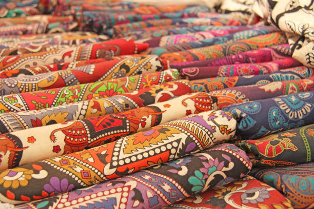 Bright colored fabrics India ornaments and oriental drawings. It is built on the market. Hand Embroidery India. Tablecloths of different colors are sold at the bazaar in India, Goa.